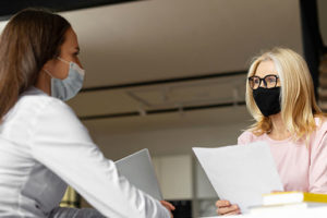 two people with medical face masks