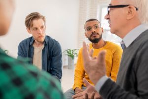 people in group therapy learning about the benefits