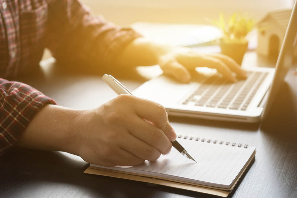 Person on laptop writing relapse prevention plan