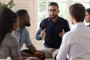 man in glasses leading participants in a dharma recovery program in mississippi 