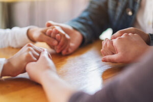 people holding hands in a celebrate recovery program in mississippi