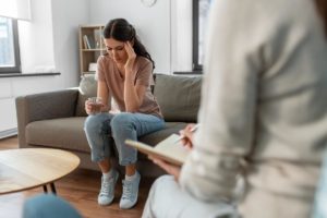 woman in jeans on couch considering an evening IOP