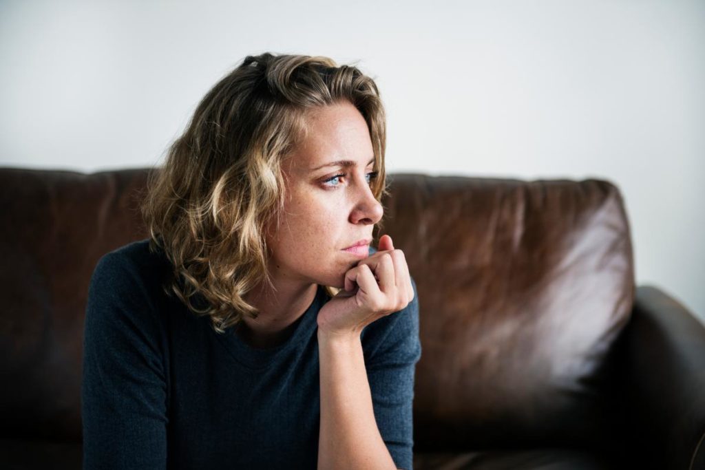 woman with blonde hair considering the symptoms of meth addiction