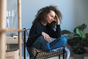 woman sitting in chair wondering how suboxone helps with withdrawal