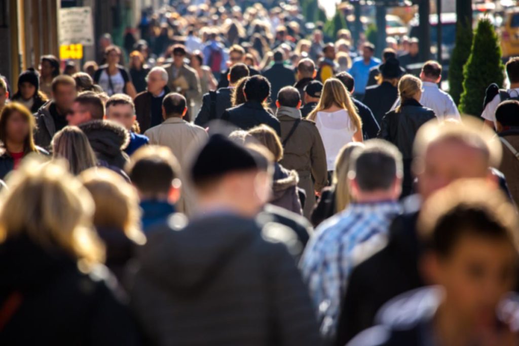 a crowd of people on a bust mississippi sidewalk