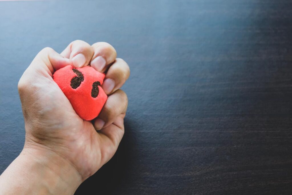 an anger management therapy client uses a stress ball to relieve intense emotions