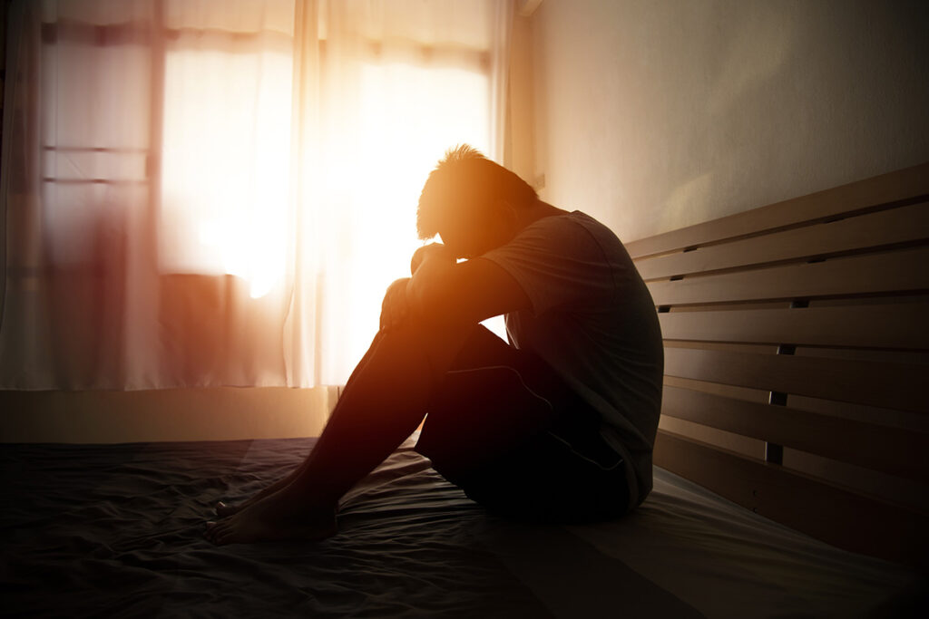 a person sits on the floor in the dark and thinks about the dangers of mixing cocaine and alcohol