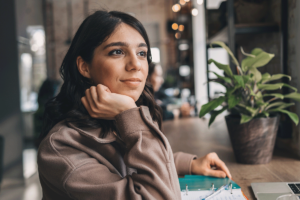 a woman looks off into the distance thinking about life after addiction