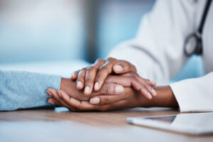 a doctor holds a patients hand while explaining suboxone treatment for opioid addiction