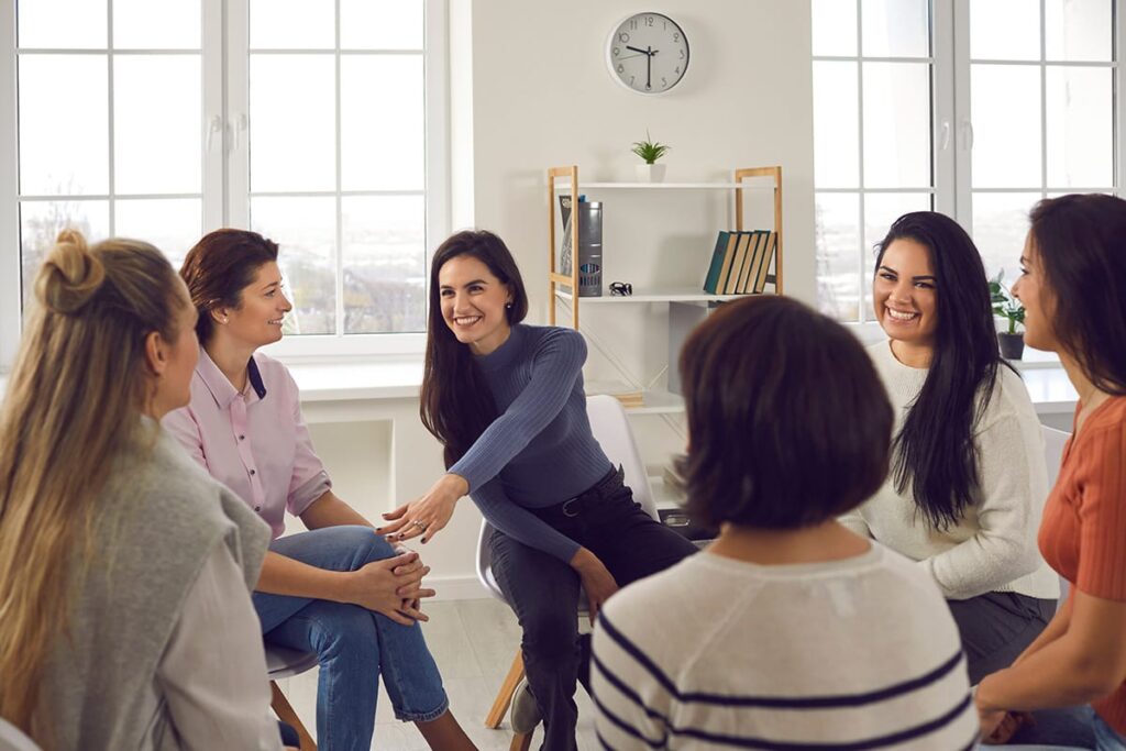 women sit around in a circle during a group therapy session at a women's alcohol rehab