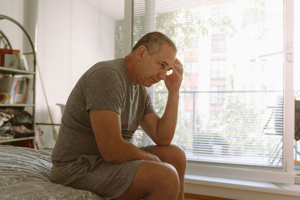 a man feels ill after a night of heavy drinking