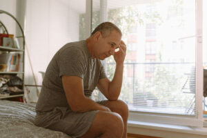 a man feels ill after a night of heavy drinking
