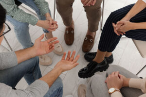 people in a huddle in a drug rehab program