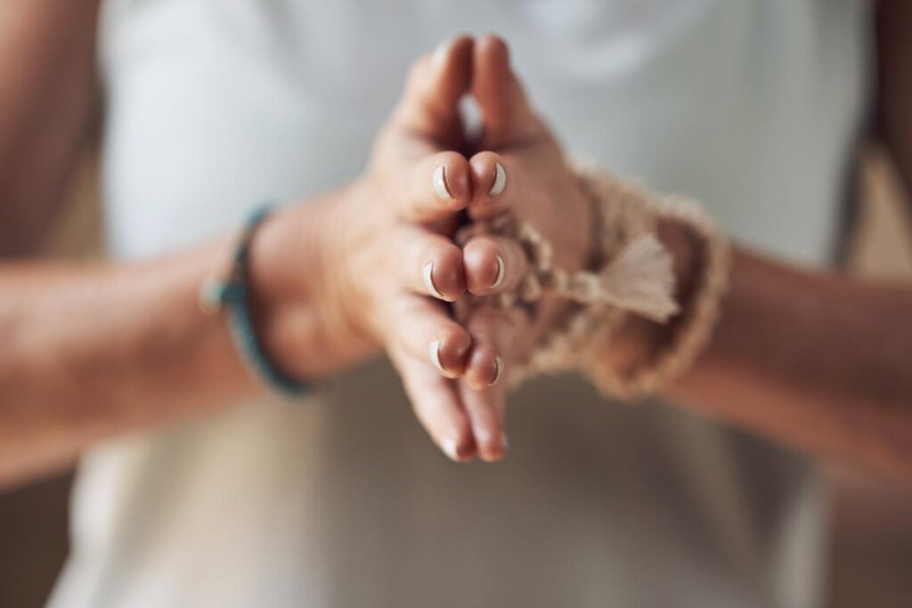 a person wearing a white shirt holds their hands together and asks what is holistic therapy