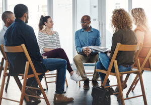 A group of people sit around in a circle and talk at a alcohol detox center in mississippi