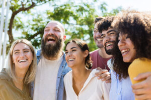 a group of people smile during a group activity for addiction recovery