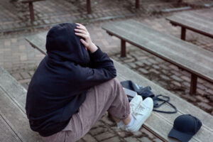 a person wearing a hoodie appearing upset and asks themselves can you die from withdrawal