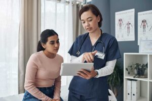 a medical professional shows paperwork to a woman patient and explaining how drug detox kits may not beneficial